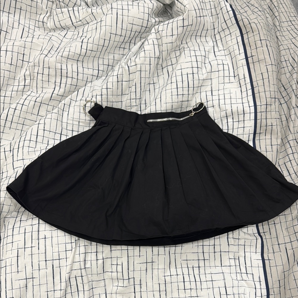 black pleated skirt with silverware accents